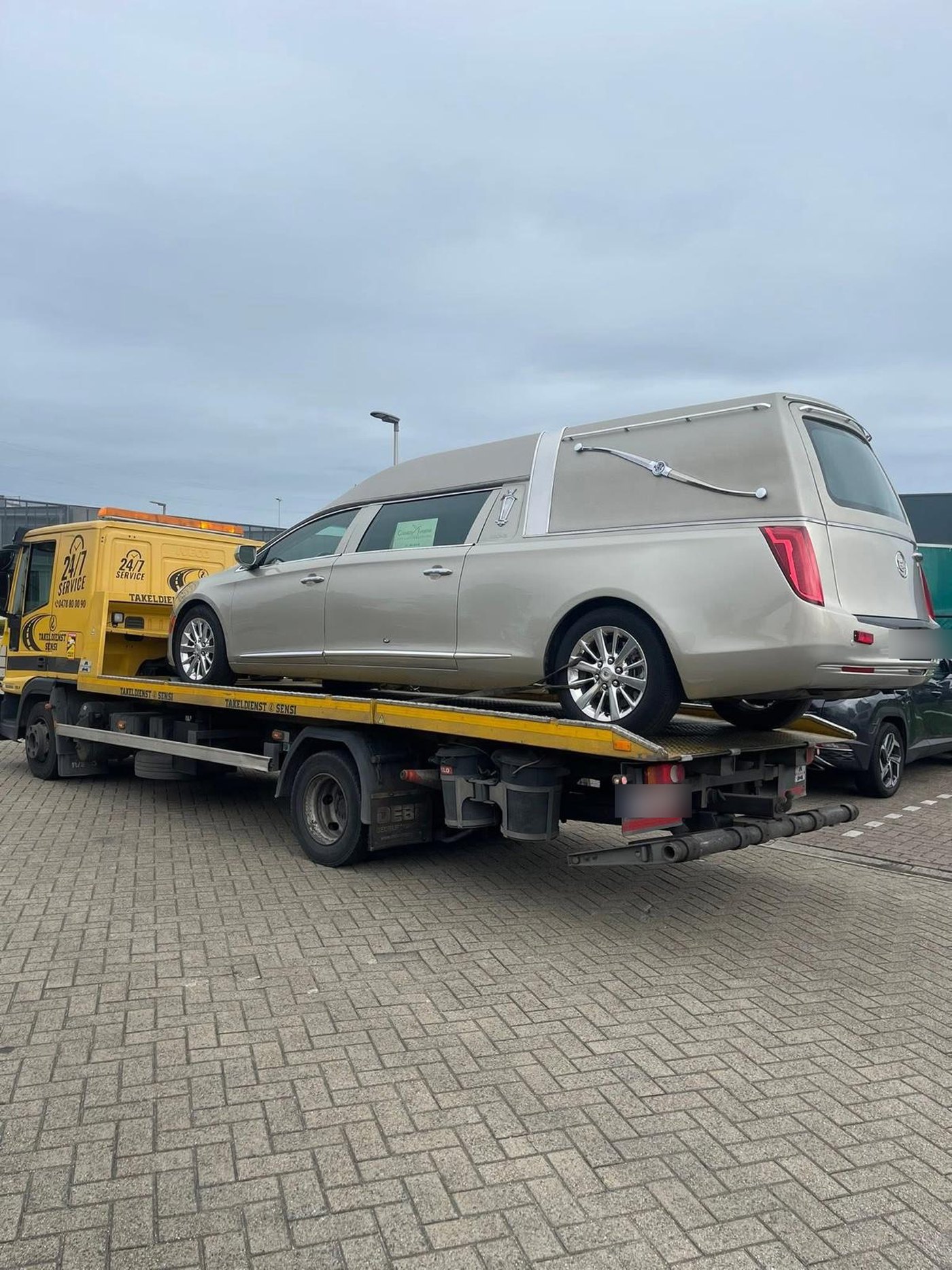 Cadillac rouwwagen op de oplegger van Takeldienst Sensi